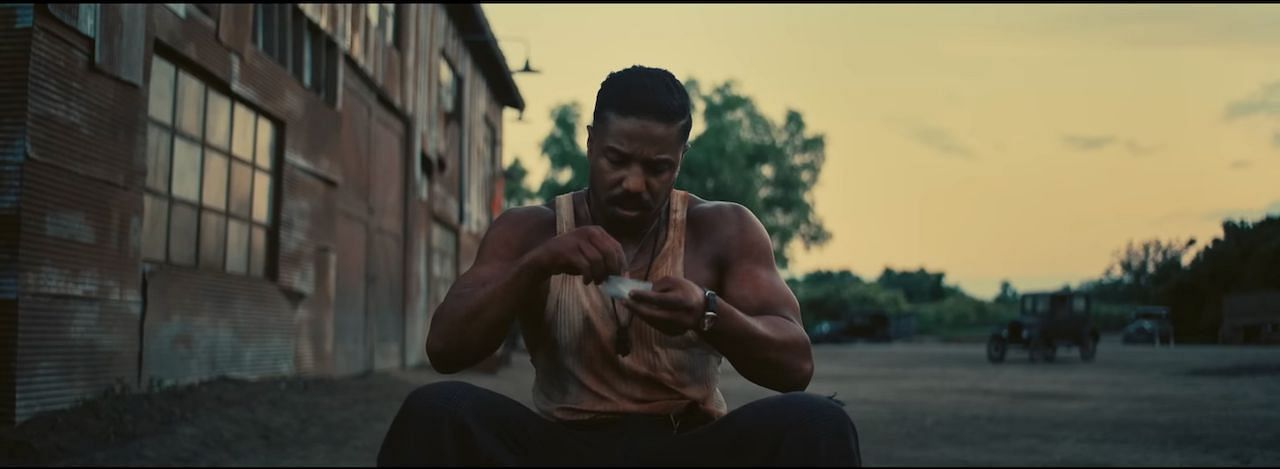 Michael B. Jordan as Elijah "Smoke" Moore in the vampire horror film Sinners. (Image via youtube.com/Warner Bros.)